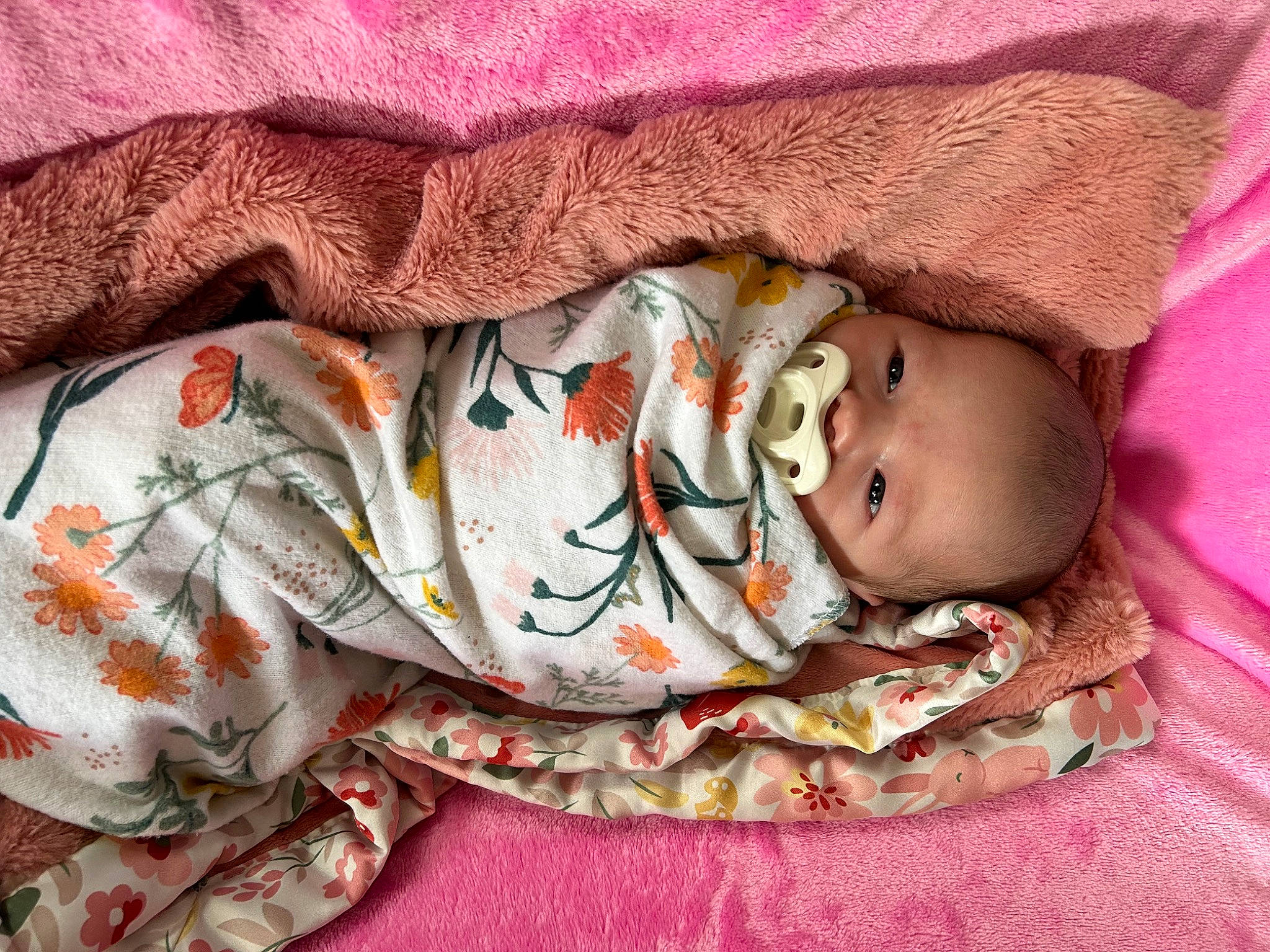 Peyton is registered to the contest to win money with this photo: baby, baby_products, baby_sleeping, baby_toddler_clothing, bed_sheet, bedding, bedtime, child, close_up, comfort, linens, magenta, pattern, peach, person, pink, room, skin, sleeve, textile