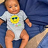 baby, infant, child, portrait, smiling, sitting, outdoor, camping_chair, blue_chair, onesie, sunglasses_design, smiley_face, barefoot, wooden_surface, woven_mat, close_up, front_facing, happy, casual_clothing, photography
