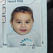 Samael is registered to the contest to win money with this photo: baby, baby_photo, child, child_photo, clothing, cute, document, face, growth_chart, happy, head, head_size, health, indoor, medical_chart, person, photo, portrait, smiling, young_child