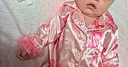Vivian is registered to the contest to win money with this photo: baby, infant, child, portrait, pink, floral, outfit, pajamas, fashion, birthday, number_two, lying_down, blanket, indoor, face, eyes, dark_hair, bow, fluffy_cuffs, photography
