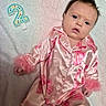 baby, infant, child, portrait, pink, floral, outfit, pajamas, fashion, birthday, number_two, lying_down, blanket, indoor, face, eyes, dark_hair, bow, fluffy_cuffs, photography