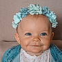 baby, child, flower_crown, blue_eyes, smile, denim_jacket, portrait, cute, indoor, headband, face, happy, infant, clothing, childhood, closeup, baby_girl, cute_expression, soft_lighting, background