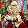 Ezra joined the competition — help win amazing prizes! baby, child, santa_claus, christmas, holiday, smile, festive, beard, red_suit, gloves, wreath, gift_boxes, decorations, tree, indoor, happy, cute, portrait, people, celebration