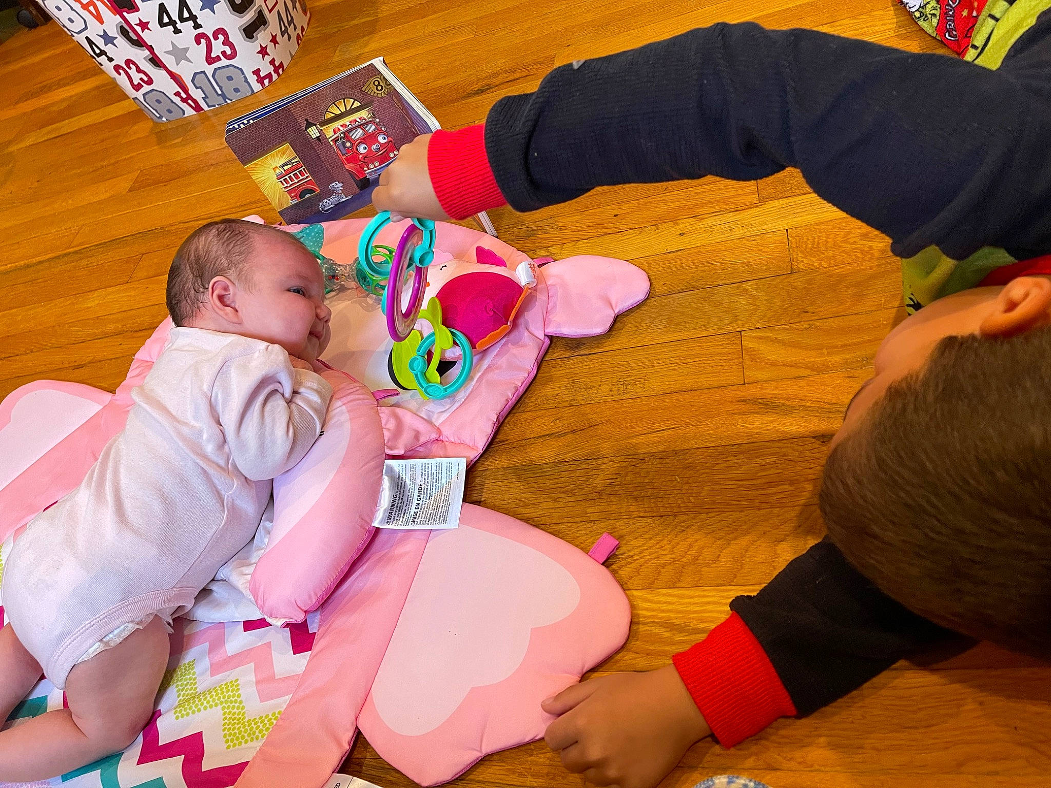 Grayson joined the competition — help win amazing prizes! baby, baby_toddler_clothing, child, comfort, event, finger, flooring, foot, fun, gesture, happy, human, joint, lap, mammal, person, sitting, sock, thigh, toddler