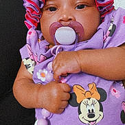 Reigna is registered to the contest to win money with this photo: baby, infant, pacifier, bonnet, purple, onesie, minnie_mouse, cartoon_character, bow, beads, hand, closeup, portrait, cute, fabric, pattern, face, chubby_cheeks, eyes, accessory