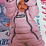 Reigna is registered to the contest to win money with this photo: child, baby, infant, pink, snowsuit, jacket, hood, bow, mittens, blanket, bedding, zipper, brand_label, lying_down, looking_up, socks, plush_toy, cozy, portrait, indoor