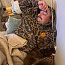 Lindo joined the competition — help win amazing prizes! man, cat, couch, blanket, hoodie, relaxed, indoor, brown_cat, white_paws, facial_hair, camouflage, cozy, pet, sleepy, table, candle, plant, water_bottle, curtains, home