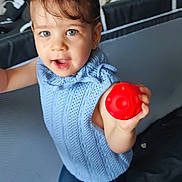 Aurore a rejoint le concours — aidez-le/la à gagner de superbes lots ! baby, blue_sweater, child, curly_hair, cushions, cute, fabric, happy, home, indoor, person, pigtails, play_area, playful, red_ball, smiling, standing, toddler, toy, young_child