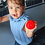 baby, blue_sweater, child, curly_hair, cushions, cute, fabric, happy, home, indoor, person, pigtails, play_area, playful, red_ball, smiling, standing, toddler, toy, young_child