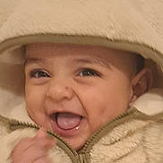 Zakaria a rejoint le concours — aidez-le/la à gagner de superbes lots ! baby, child, smiling, happy, hood, jacket, fleece, warm_clothing, cute, face, tongue, dimples, portrait, infant, young_child, close_up, hands, zipper, apparel, indoors