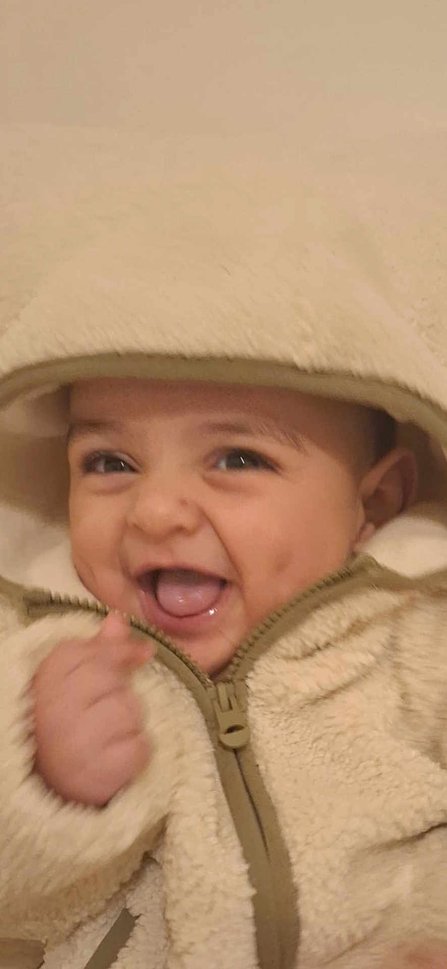 Zakaria a rejoint le concours — aidez-le/la à gagner de superbes lots ! baby, child, smiling, happy, hood, jacket, fleece, warm_clothing, cute, face, tongue, dimples, portrait, infant, young_child, close_up, hands, zipper, apparel, indoors