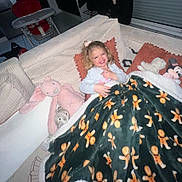 Kélia participe au concours pour gagner de l'argent avec cette photo : blanket, child, couch, cozy, curtains, furniture, gingerbread_man, girl, happy, high_chair, home_interior, indoor, living_room, minnie_mouse, person, pillow, pink_bear, plush_toy, smiling, tile_floor