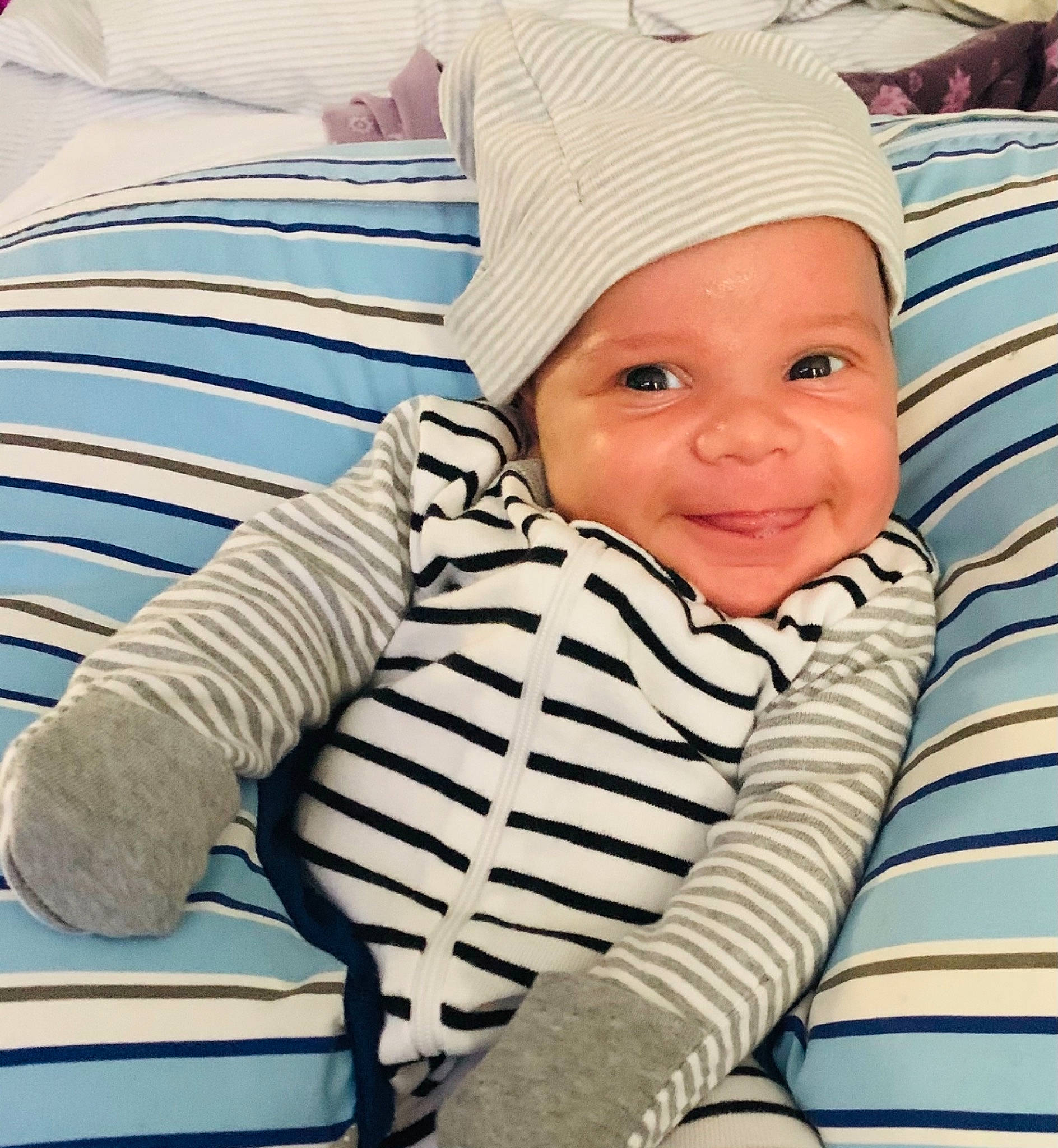 Enzo is registered to the contest to win money with this photo: baby, baby_sleeping, baby_toddler_clothing, beanie, blue, cap, chair, child, comfort, electric_blue, happy, headwear, joy, knit_cap, linens, pattern, person, sitting, skin, sleeve