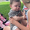 Gracelyn is registered to the contest to win money with this photo: baby, child, pouting, outdoor, grass, stroller, holding, person, diaper, leopard_print, summer, cute, expression, face, portrait, skin, hair, hand, sitting, play