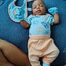 Willow joined the competition — help win amazing prizes! baby, infant, blue_clothing, gloves, bib, lying_down, blue_blanket, orange_pants, baby_socks, person, skin, legs, cute, portrait, indoor, child, newborn, smiling, resting, casual