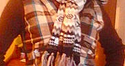 Willow is registered to the contest to win money with this photo: person, child, glasses, hat, scarf, plaid, indoor, jeans, belt, standing, warm_clothing, smile, casual, portrait, fashion, young, hands_on_hips, cozy, winter, accessory