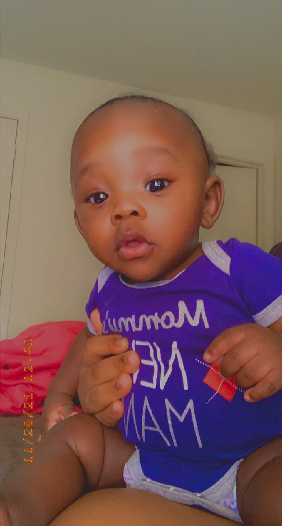 Dakari is registered to the contest to win money with this photo: baby_toddler_clothing, cheek, chin, ear, eye, eyebrow, forehead, gesture, hair, hand, happy, iris, joint, lip, mouth, neck, nose, person, shoulder, skin