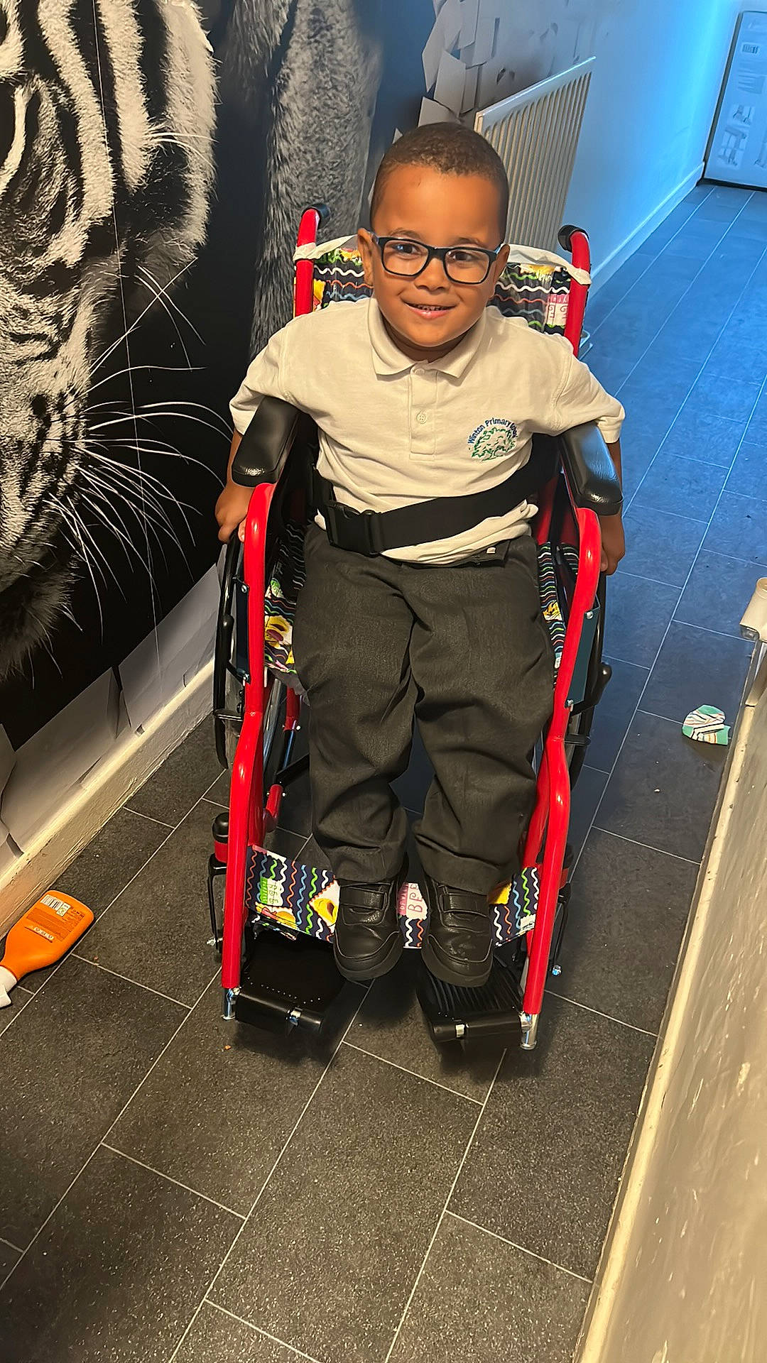 Nico is registered to the contest to win money with this photo: automotive_design, bag, chair, cleanliness, costume, eyewear, fictional_character, flooring, fun, games, joy, luggage_and_bags, person, personal_protective_equipment, recreation, room, smile, t_shirt, toddler, visual_arts