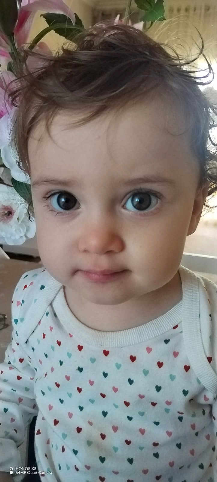 Aliya participe au concours pour gagner de l'argent avec cette photo : toddler, child, face, eyes, hair, clothing, heart_pattern, portrait, indoor, flower, curly_hair, cute, young, baby, person, closeup, expression, soft_light, innocent, casual