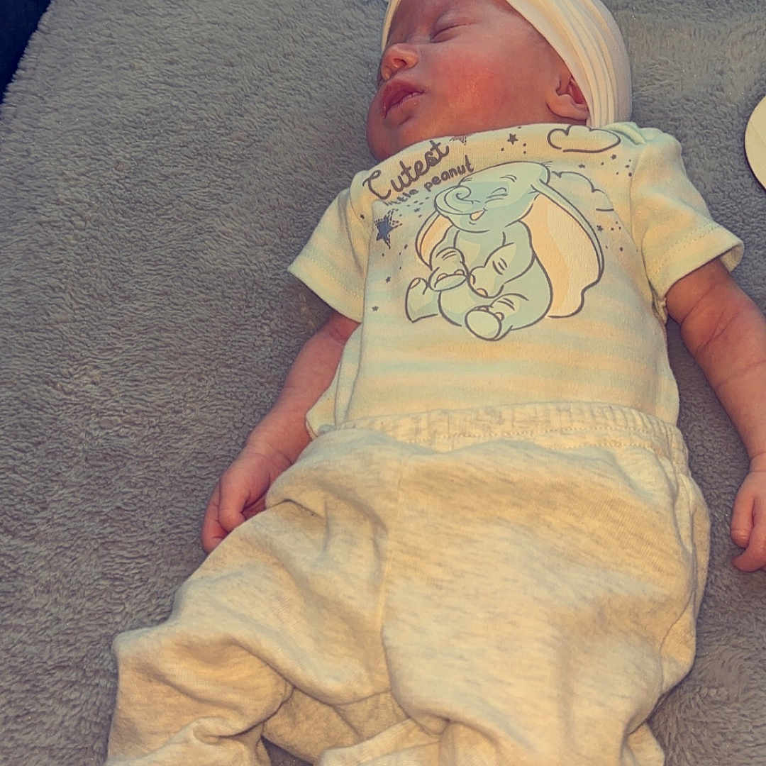 Delilah joined the competition — help win amazing prizes! baby, bed, blanket, bodypart, bonnet, clothing, couch, face, finger, furniture, glove, hand, hat, head, newborn, person, photography, portrait, quilt, sleeping