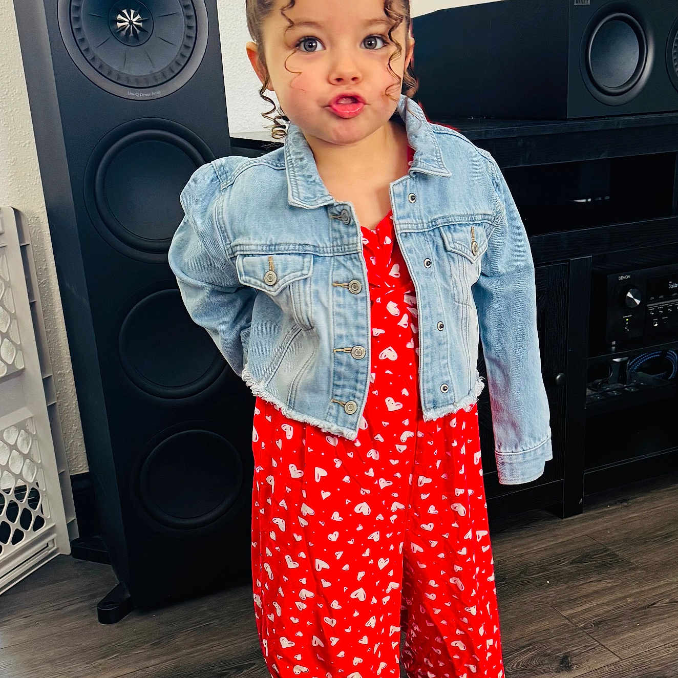 Jaylene is registered to the contest to win money with this photo: child, clothing, coat, electronics, face, female, girl, happy, head, jeans, longsleeve, pajamas, pants, person, photography, portrait, sleeve, smile, speaker, standing