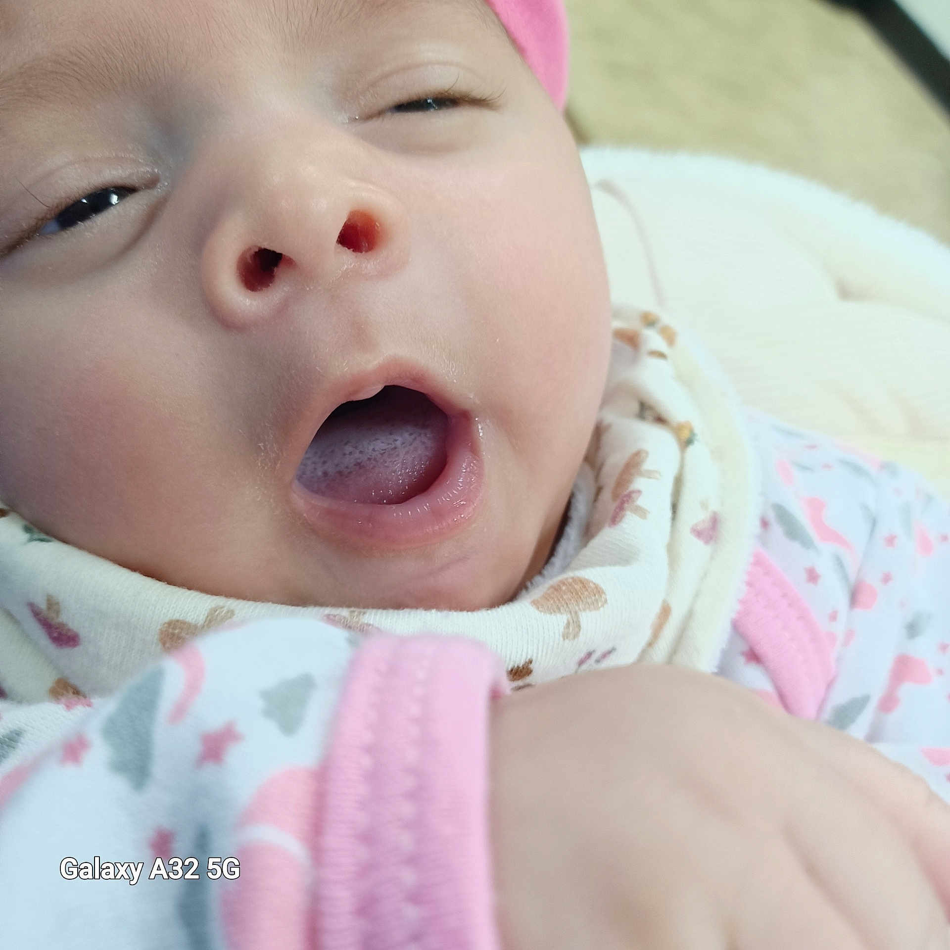 Yassmine is registered to the contest to win money with this photo: baby, child, close_up, clothing, cute, fabric, face, hand, hat, indoors, infant, mouth_open, newborn, pattern, pink, portrait, skin, sleepy, soft, yawning
