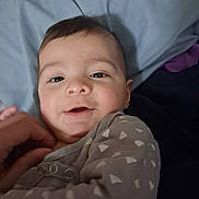 Yassmine joined the competition — help win amazing prizes! baby, bed, child, clothing, cute, expression, eyes, face, hand, head, indoor, infant, lying_down, pajamas, person, portrait, skin, sleepwear, smiling, young