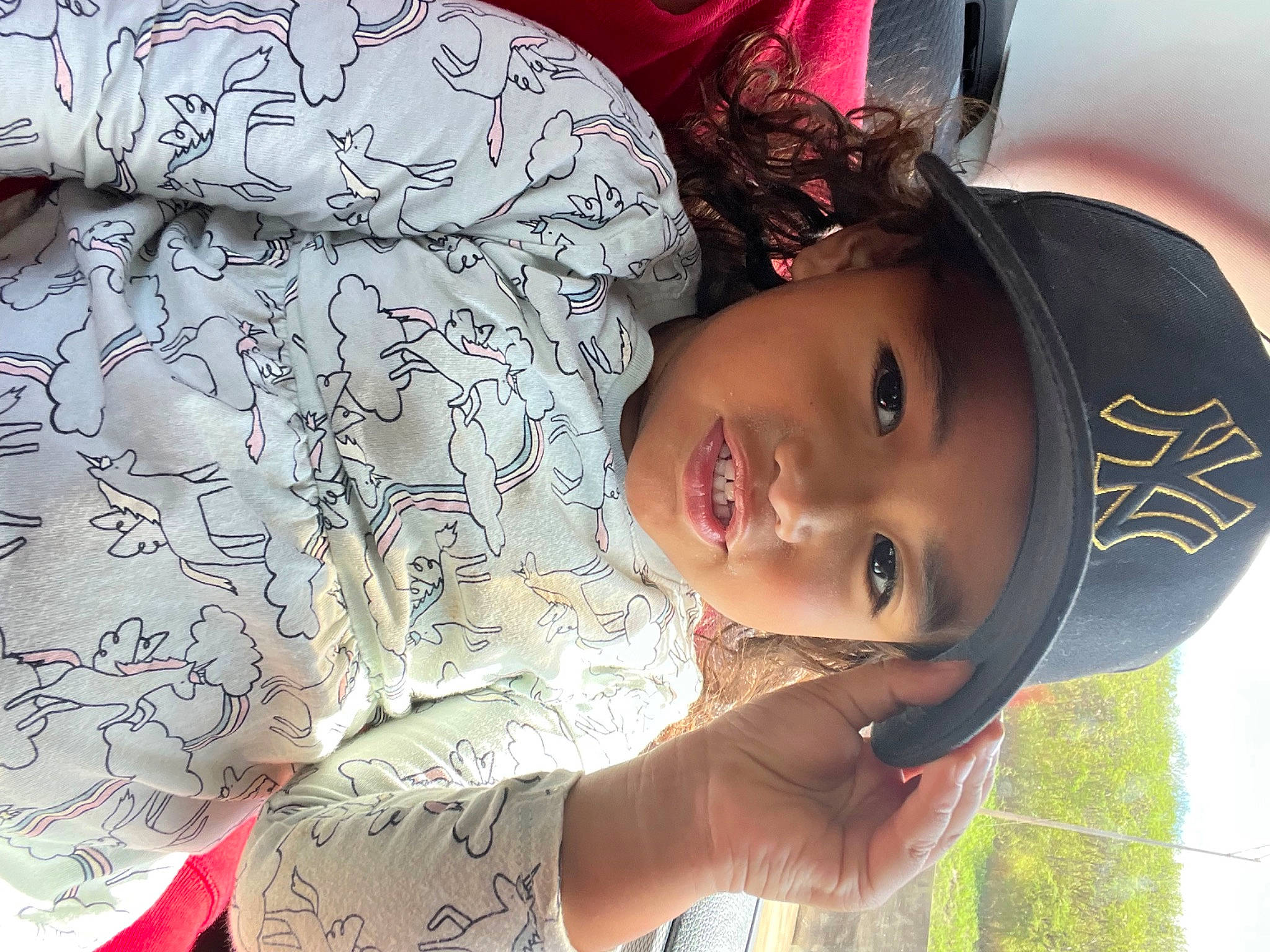 Maila is registered to the contest to win money with this photo: arm, child, cool, eye, eyelash, face, fun, happy, hat, headwear, linens, lip, mouth, neck, nose, pattern, person, plant, skin, smile