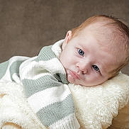 Owenn a rejoint le concours — aidez-le/la à gagner de superbes lots ! baby, blanket, blue_eyes, child, close_up, cozy, cute, expression, face, hair, indoor, infant, lying_down, portrait, resting, skin, soft_texture, striped_clothing, sweater, young
