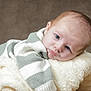 baby, blanket, blue_eyes, child, close_up, cozy, cute, expression, face, hair, indoor, infant, lying_down, portrait, resting, skin, soft_texture, striped_clothing, sweater, young