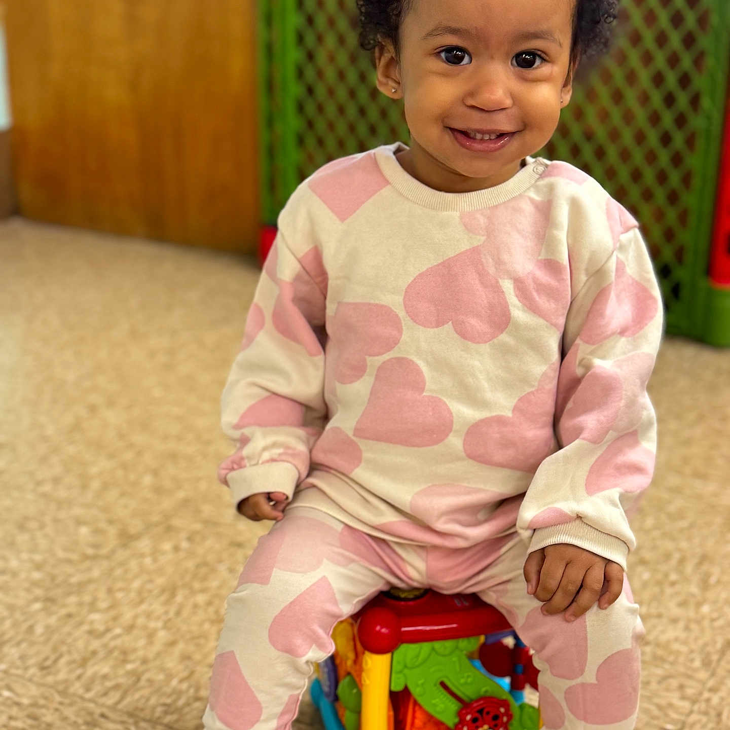 Alexandra is registered to the contest to win money with this photo: bodypart, child, clothing, face, female, finger, footwear, girl, hand, happy, head, indoors, longsleeve, person, photography, portrait, shoe, sitting, sleeve, smile