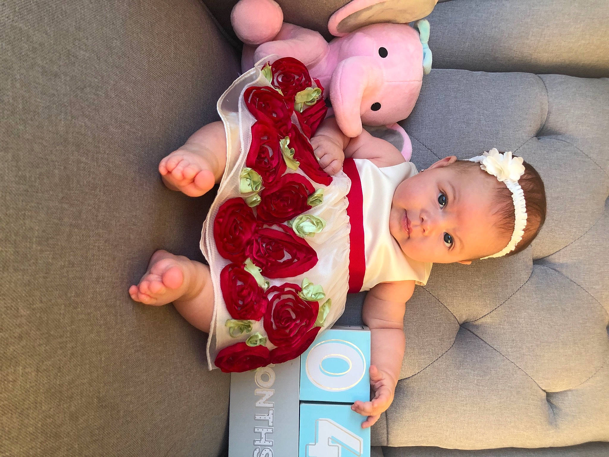 Wren is registered to the contest to win money with this photo: baby, baby_products, baby_toddler_clothing, baby_toys, couch, hair_accessory, headband, nail, peach, person, pink, plush, skin, stuffed_toy, teddy_bear, toy
