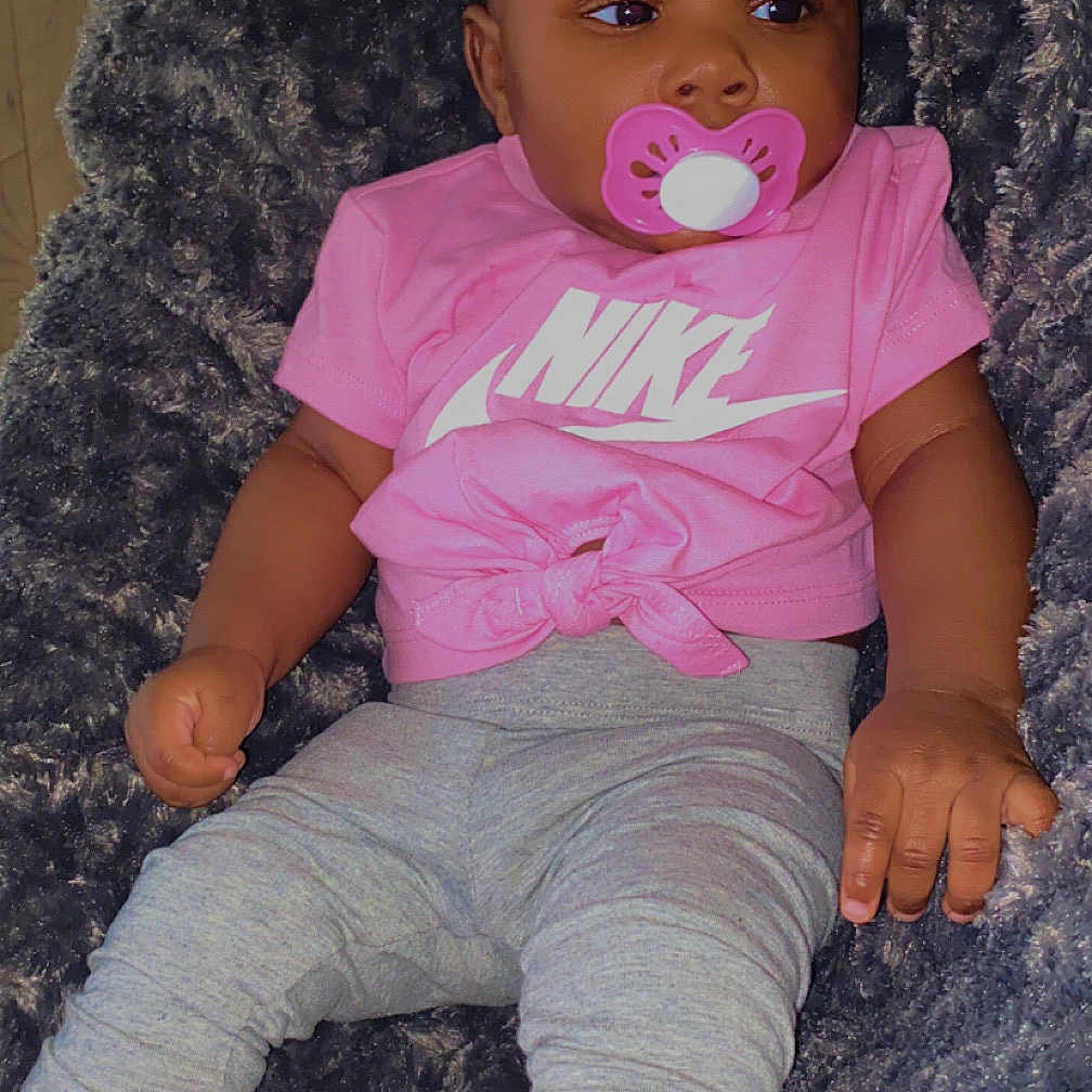 Royale is registered to the contest to win money with this photo: adorable, baby, baby_booties, baby_girl, child, clothing, cute, fluffy_blanket, gray_leggings, head_accessory, indoor, infant, lying_down, nike_shirt, pacifier, person, pink_bow, portrait, relaxing, soft_texture