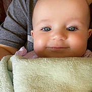 Lexley is registered to the contest to win money with this photo: baby, infant, blanket, smile, face, child, person, closeup, soft, cute, eyes, drool, comfort, warm, toddler, clothing, portrait, skin, head, resting