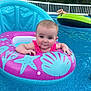 baby, child, pool, water, inflatable, float, pink, blue, green, swimming, summer, outdoor, backyard, person, relaxing, fun, cute, face, expression, vacation