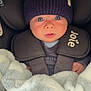 Archie is registered to the contest to win money with this photo: baby, infant, car_seat, hat, knit_hat, blanket, pacifier, child, blue_eyes, clothing, straps, closeup, face, cute, young_child, indoor, warm, soft_texture, person, portrait
