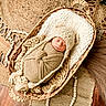 Jaxon is registered to the contest to win money with this photo: newborn, baby, sleeping, basket, knitted_wrap, knitted_hat, woven_basket, rug, wooden_floor, cozy, resting, infant, cute, soft_lighting, indoors, portrait, wrapped, peaceful, natural_colors, texture