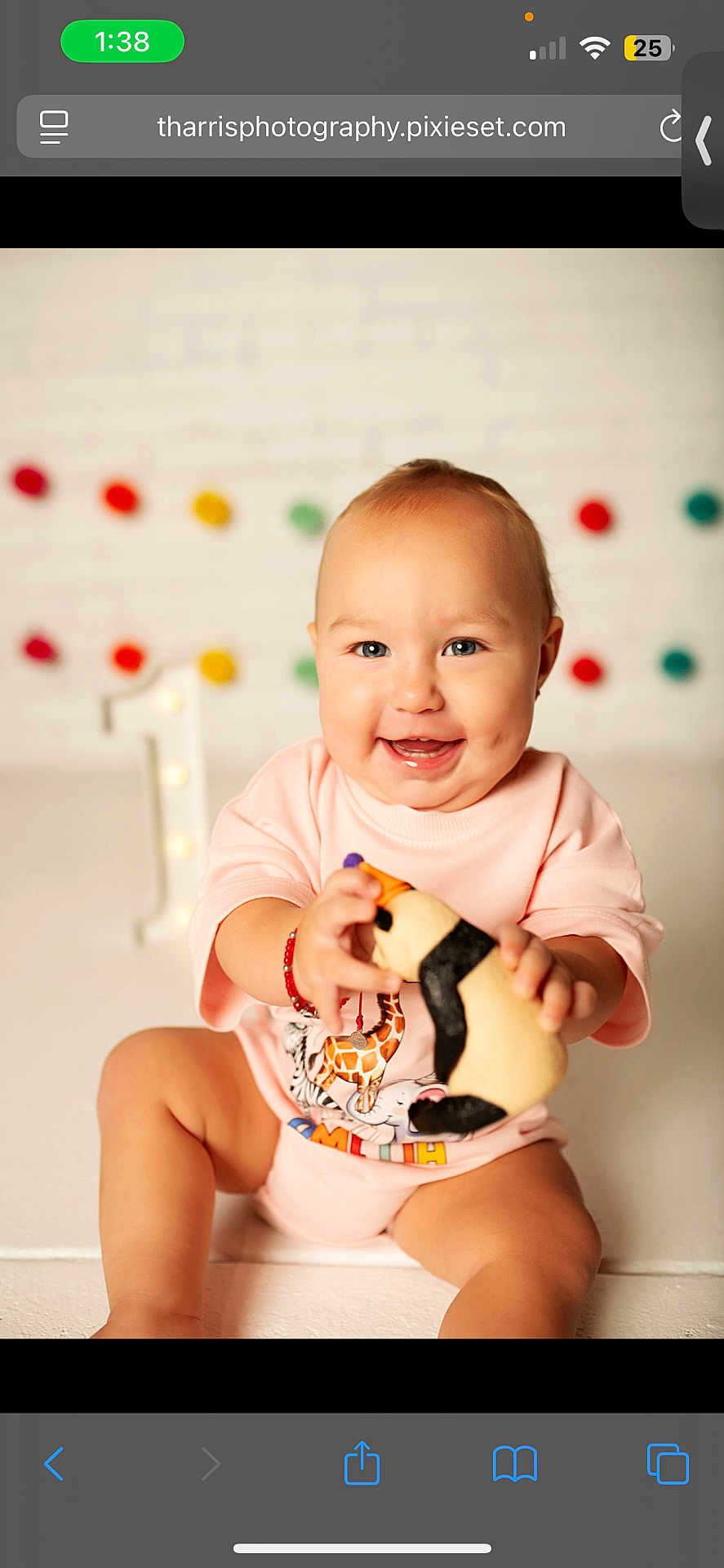 Amelia joined the competition — help win amazing prizes! baby, child, smiling, pink_clothing, plush_toy, penguin_toy, dimples, birthday, number_one, decorations, colorful_pom_poms, white_brick_wall, sitting, happy, cute, portrait, indoors, bracelet, toy, celebration