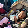 Kaylani is registered to the contest to win money with this photo: baby, bottle, car_interior, car_seat, child, clothing, cute, drinking, hair_clips, indoors, infant, peaceful, pink_pants, portrait, relaxed, safety, seat, seatbelt, sunlight, young_child