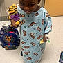 Chase joined the competition — help win amazing prizes! child, hospital_gown, stuffed_toy, tiger, backpack, smile, hospital_room, floor, medical_tape, snack, braided_hair, person, indoor, toy, childrens_clothing, happy, young_child, playful, healthcare, waiting_room