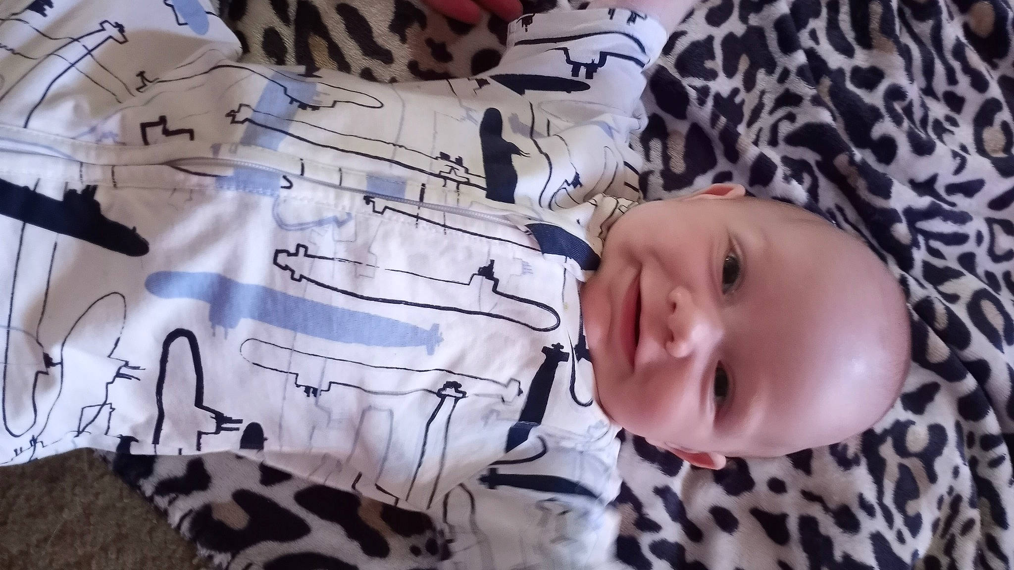 Jayden is registered to the contest to win money with this photo: baby, baby_toddler_clothing, black, carmine, cheek, child, comfort, font, headwear, joy, linens, pattern, person, room, sleeve, smile, textile, toddler, visual_arts, white