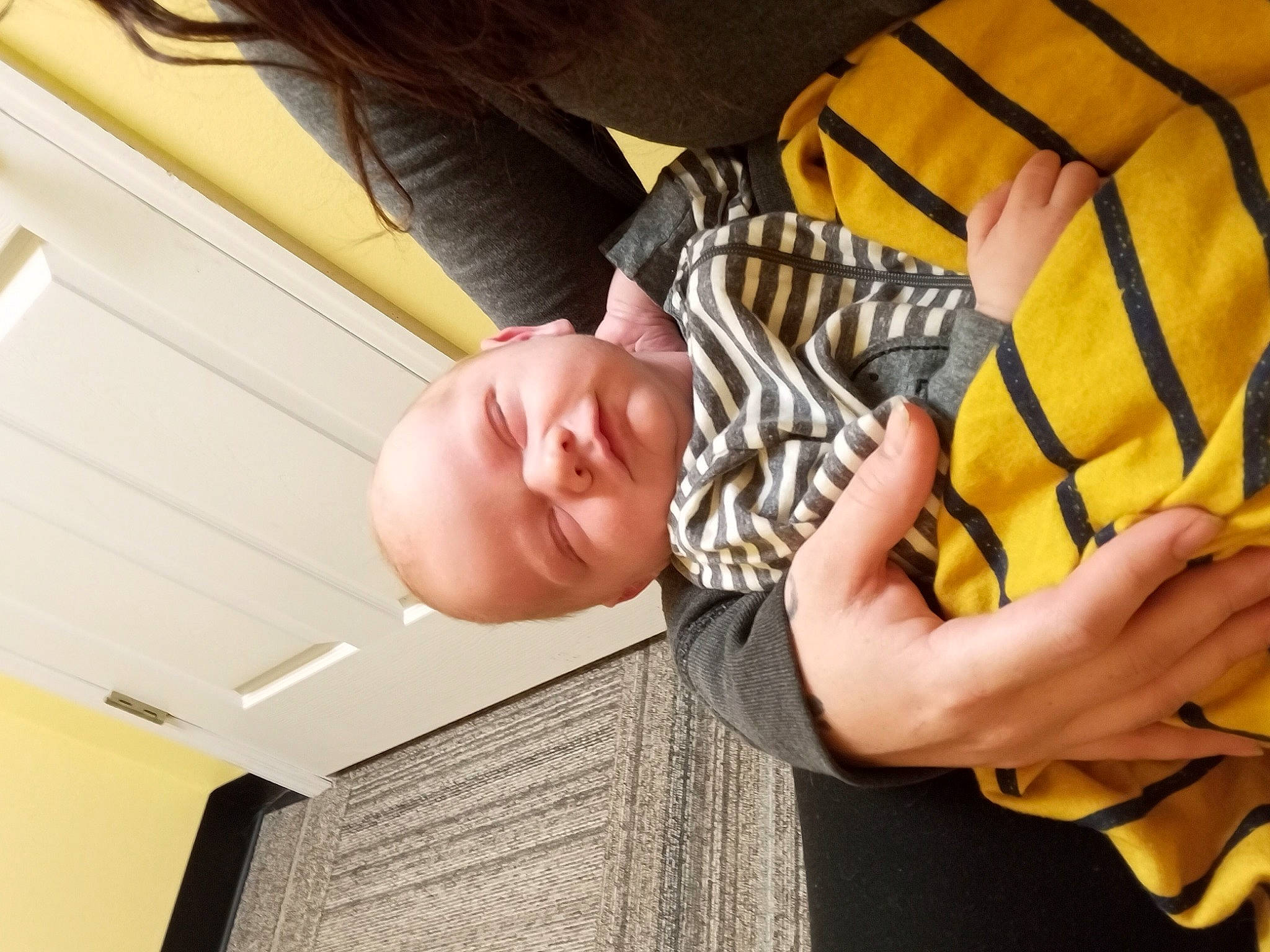 Jayden is registered to the contest to win money with this photo: baby, child, comfort, elbow, finger, fun, gesture, hand, happy, human_leg, knee, mouth, person, shoulder, sitting, sleeve, smile, thigh, toddler, wood