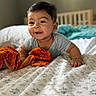 Atharv is registered to the contest to win money with this photo: baby, smiling, bed, blanket, orange_cloth, crib, indoor, child, happy, infant, face, person, sleepwear, home, furniture, cute, portrait, soft_light, toddler, cozy