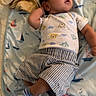 Noah Isaiah Santos joined the competition — help win amazing prizes! baby, infant, child, lying_down, bed, bedding, sailboat_pattern, onesie, striped_shorts, socks, clothing, portrait, face, open_mouth, curious, looking_up, indoors, cozy, nursery, photograph