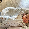 newborn, baby, infant, child, portrait, lying_down, onesie, clothing, blanket, bed, bedding, pillow, face, eyes, hair, indoors, sunlight, wooden_floor, cozy, photography