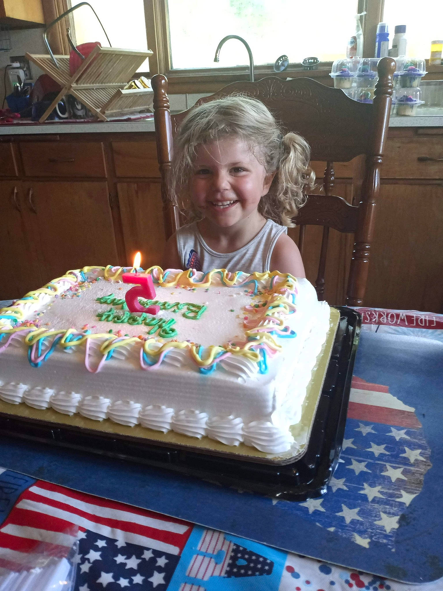 Julie is registered to the contest to win money with this photo: baked_goods, birthday, birthday_cake, birthday_candle, buttercream, cake, cake_decorating, cake_decorating_supply, candle, chair, cuisine, dessert, food, ingredient, joy, person, smile, sugar_cake, sugar_paste, sweetness