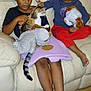 Naia participe au concours pour gagner de l'argent avec cette photo : child, children, cat, stuffed_toy, couch, blanket, floor, pacifier, indoor, playing, curly_hair, short_hair, barefoot, purple_blanket, red_pants, black_shirt, white_couch, pet, holding, sitting