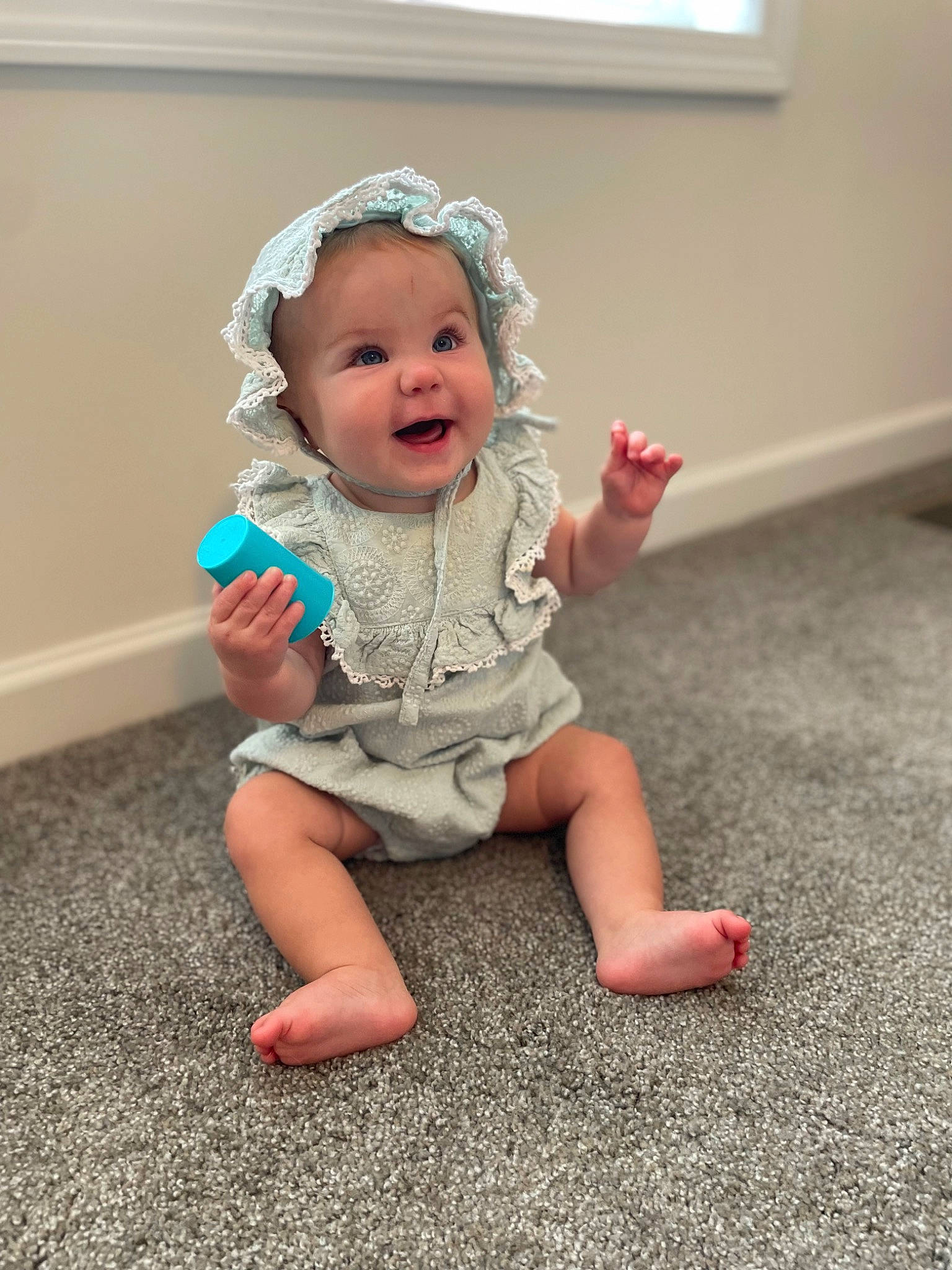 Macie joined the competition — help win amazing prizes! baby, baby_toddler_clothing, barefoot, child, clothing, flooring, foot, fun, gesture, grass, happy, human_leg, knee, person, sitting, skin, sleeve, smile, thumb, toddler