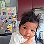 appliance, baby, cabinet, child, curious, cute, domestic, expression, face, fridge, hair, hand, holding, indoor, kitchen, magnet, person, plant, portrait, white_clothing