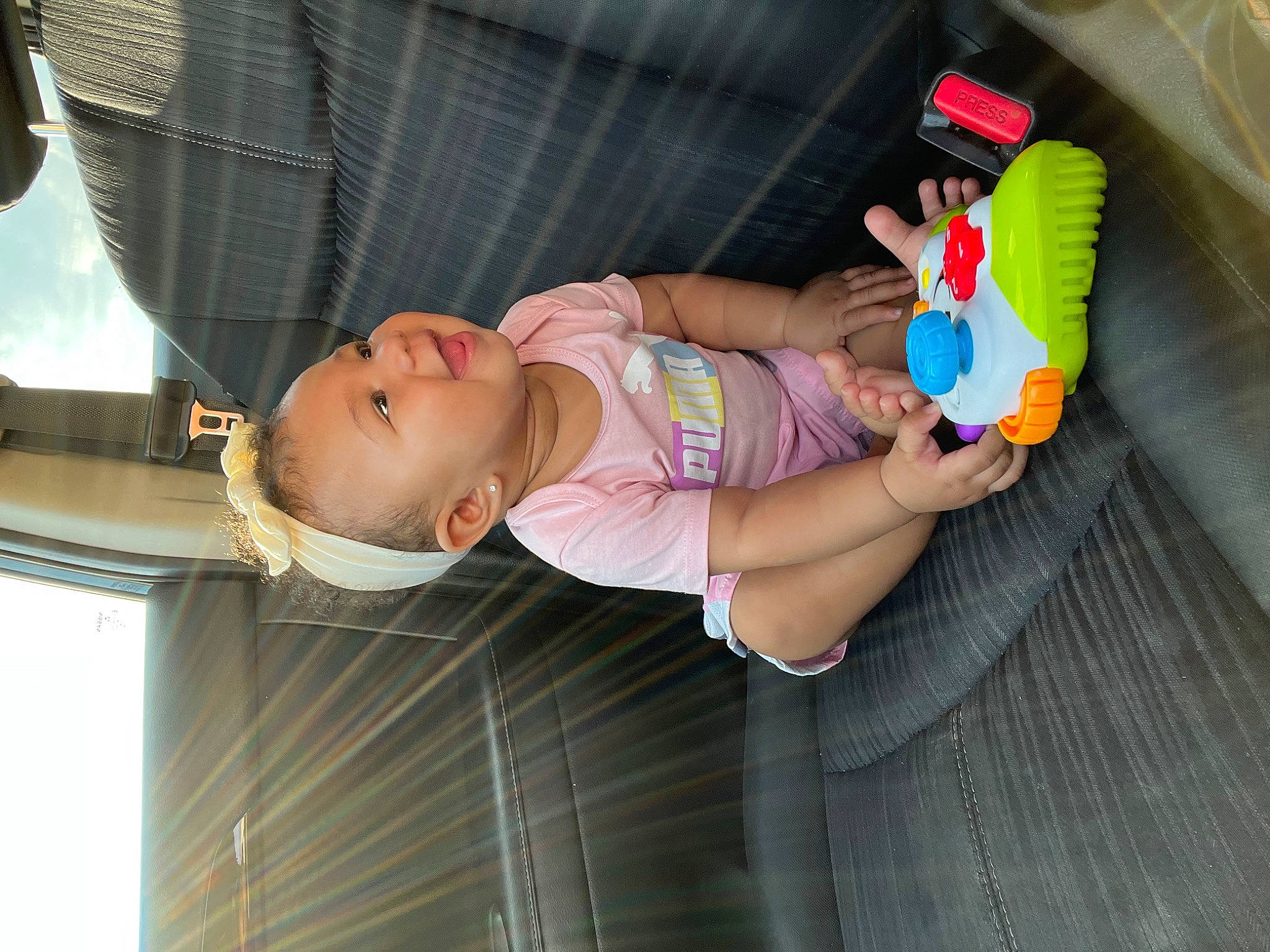 Blu is registered to the contest to win money with this photo: baby, baby_products, baby_toddler_clothing, child, elbow, fun, nail, person, smile, stuffed_toy, thumb, toddler, toy